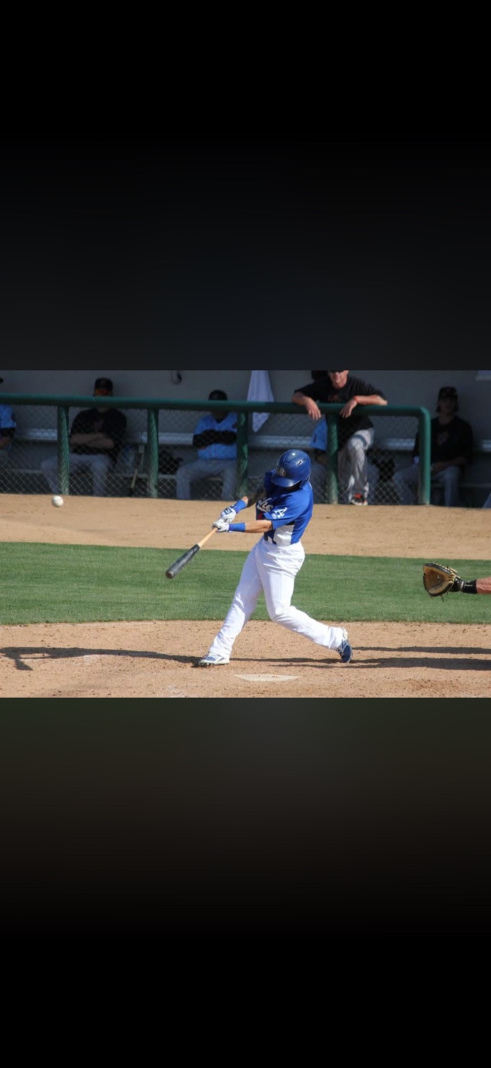 Robbie swinging at a pitch during his professional baseball years